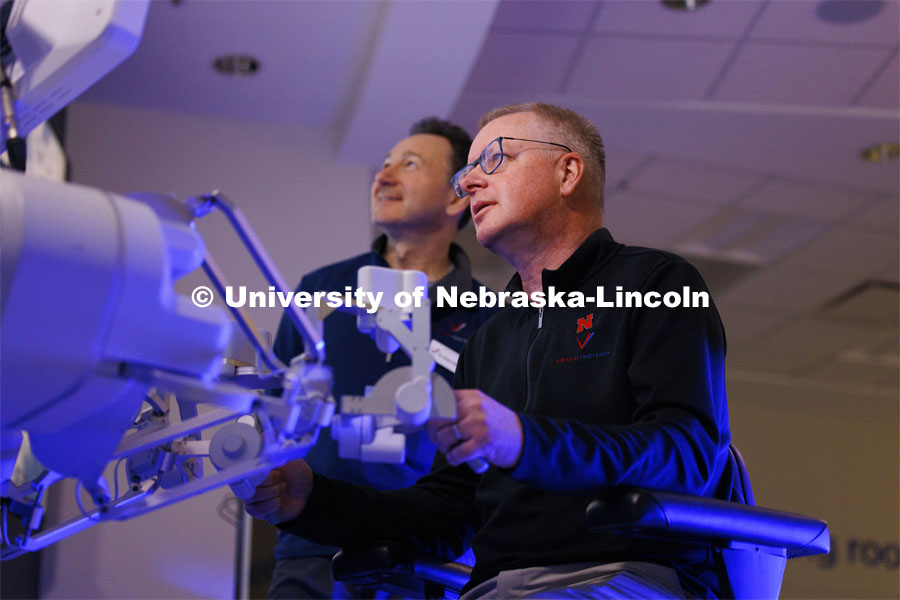 Nebraska Engineering professor and Virtual Incision founder Shane Farritor takes a turn using the surgical robot as Dr. Dmitry Oleynikov watches. Virtual Incision successfully performed robotic surgery on the International Space Station. Controlled from the Virtual Incision offices in Lincoln, NE, surgeons cut rubber bands–mimicking surgery–inside a payload box on the International Space Station. February 10, 2024. Photo by Craig Chandler / University Communication and Marketing.