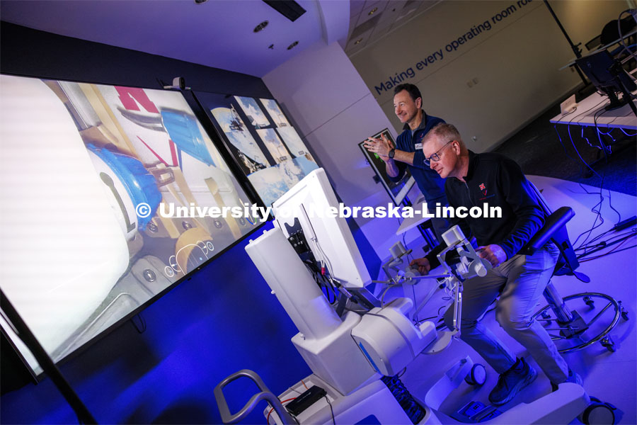 Nebraska Engineering professor and Virtual Incision founder Shane Farritor takes a turn using the surgical robot as Dr. Dmitry Oleynikov applauds a successful cut. Virtual Incision successfully performed robotic surgery on the International Space Station. Controlled from the Virtual Incision offices in Lincoln, NE, surgeons cut rubber bands–mimicking surgery–inside a payload box on the International Space Station. February 10, 2024. Photo by Craig Chandler / University Communication and Marketing.