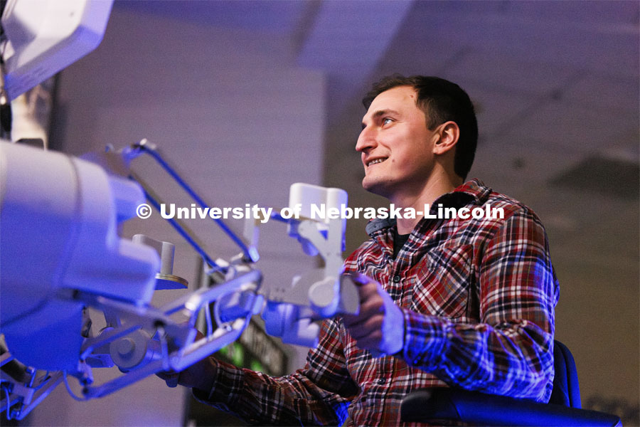 Virtual Incision employee Lou Cubrich gets a chance at surgically cutting a rubber band on the International Space Station. Nebraska Engineering professor and Virtual Incision founder Shane Farritor successfully performed robotic surgery on the International Space Station. Controlled from the Virtual Incision offices in Lincoln, NE, surgeons cut rubber bands–mimicking surgery–inside a payload box on the International Space Station. February 10, 2024. Photo by Craig Chandler / University Communication and Marketing.
