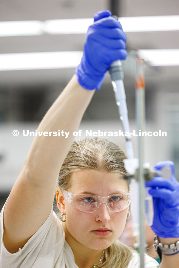 Serena Henry adds solution to drip through the lab setup to awaiting test tubes. Students isolate and purify lysozyme from actual egg whites in BIOC 401L - Laboratory for Elements of Biochemistry. February 13, 2024. Photo by Craig Chandler / University Communication and Marketing.