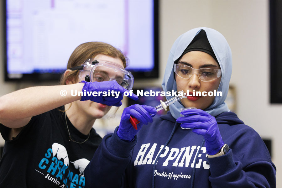 Nora Alawseh, right, dilutes a solution during a lab entitled “kinetics at work” with lab partner Alexis Montecuollo. Hamilton Hall chemistry 110 lab. February 29, 2024. Photo by Craig Chandler / University Communication and Marketing.