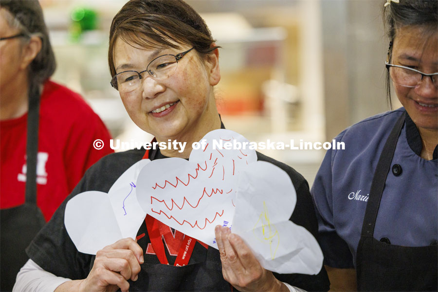 Kaori Contreras holds the hearts decorated by the children. Children crowd in to give appreciation hearts to the food service workers in the Nebraska East Union. Students in the Ruth Staples Child Development Lab go on a field trip to the Nebraska East Union and a walk around campus. March 1, 2024. Photo by Craig Chandler / University Communication and Marketing.