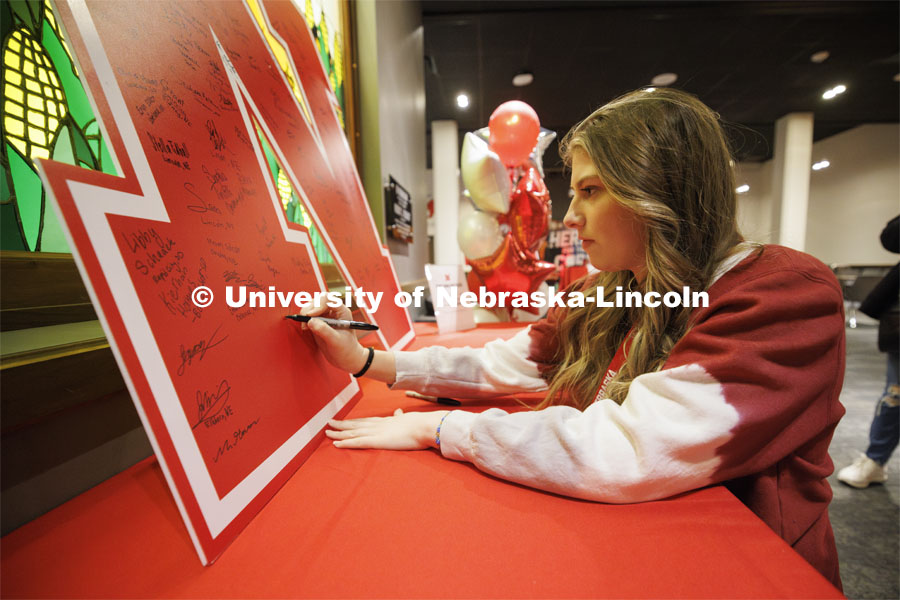 Bailey Ridder of Broken Bow, Nebraska, signs a large “N” poster inside the Nebraska Union. Admitted Student Day is UNL’s in-person, on-campus event for all admitted students. March 23, 2024. Photo by Craig Chandler / University Communication and Marketing.