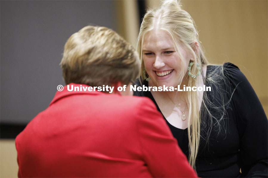 Aspiring teacher Emma Henderson of Superior, Nebraska, accepts her pin from CEHS 2024 alumni master Marilyn Moore. The second-year student has been admitted to the elementary education program in the College of Education and Human Sciences. April 5, 2024. Photo by Craig Chandler / University Communication and Marketing.