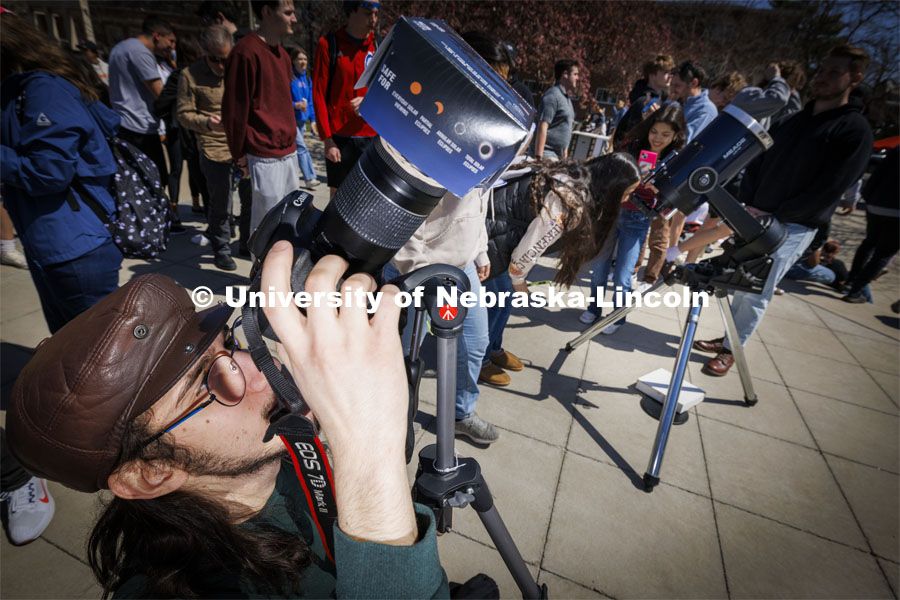 A photographer uses a special lense to photograph the eclipse. The Solar Social party to view the partial solar eclipse filled the greenspace outside the Nebraska Union on City Campus. April 8, 2024. Photo by Craig Chandler / University Communication and Marketing.