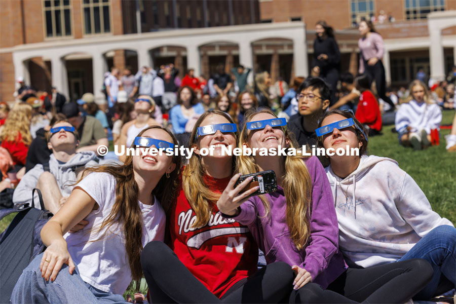 Ava Johnson, Kori Koepper, Christina Schaben and Samantha Pehrson take a selfie of the group watching the eclipse. The Solar Social party to view the partial solar eclipse filled the greenspace outside the Nebraska Union on City Campus. April 8, 2024. Photo by Craig Chandler / University Communication and Marketing.