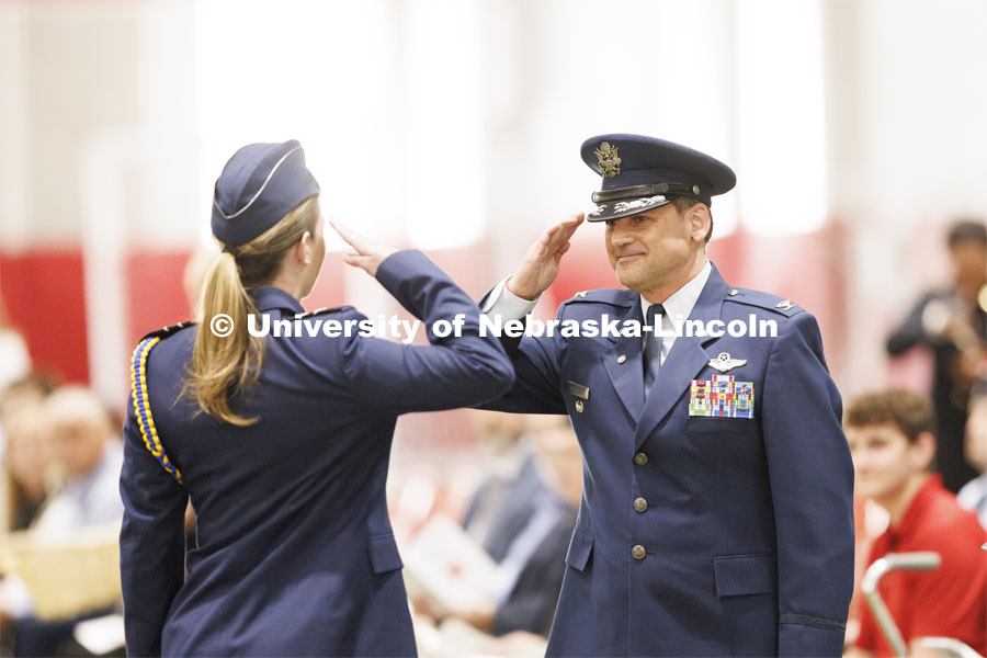 Retired Col. Joe Brownell, executive director of the military/veteran success center, returns the salute of cadet Olivia Fortin after she received the Kinman-Oldfield scholarship. Joint Service Chancellor’s Review of the ROTC Cadets in Cook Pavilion. April 18, 2024. Photo by Craig Chandler / University Communication and Marketing.
