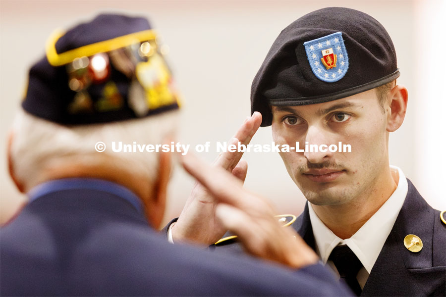 Cadet Lawrence Miller salutes after receiving his American Legion Post 3 General Scholastic Excellence Award. Joint Service Chancellor’s Review of the ROTC Cadets in Cook Pavilion. April 18, 2024. Photo by Craig Chandler / University Communication and Marketing.