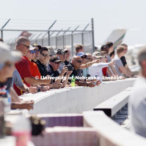The NASCAR tour group, media and others watch the crash test from behind barriers. Test of bull-nose barrier for use in medians to protect cars from overpass columns. Test was at university's Midwest Roadside Safety Facility at the Lincoln airport. June 5