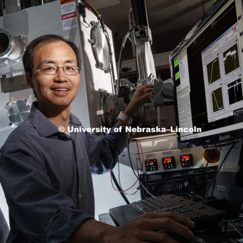 Xiaoshan Xu, assistant professor of physics and astronomy, has received a 2018 Early Career Award from the U.S. Department of Energy.
Xiaoshan works on organic electrical circuits. July 5, 2018. Photo by Craig Chandler / University Communication.
