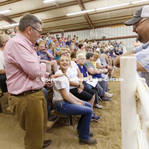 Kiley Weichel of Plymouth, Nebraska, smiles as Chancellor Ronnie Green relates a story of his youth showing cattle. Green was at the Jefferson County Fair Junior Beef Show in Fairbury, Nebraska. July 13, 2018. Photo by Craig Chandler / University