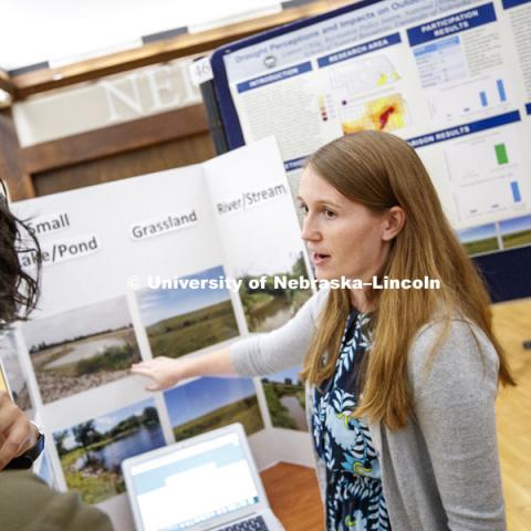Lauren Uhlig explains her summer research "Drought Perception and Impacts on Outdoor Recreation in the Great Plains" during Tuesday's poster session. Summer Undergraduate Research Fair poster session in the Nebraska Union Ballroom. August 7, 2018. Photo
