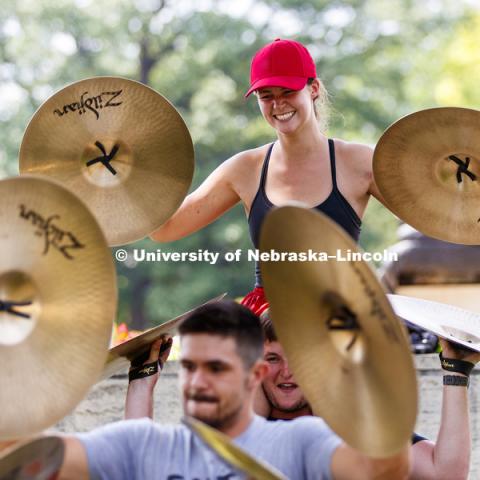 Lauren McNeal sits on Logan Dickey's shoulders as they practice the cymbal line's pre-game routine. Cornhusker Marching Band practice.  August 12, 2018. Photo by Craig Chandler / University Communication.
