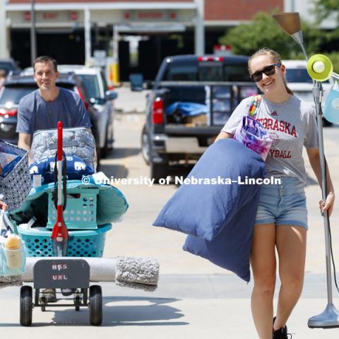 New freshman Emily Zimmerman, left, and her sister, Olivia, carry Emily's stuff toward Smith Hall. Housing move in for sorority rush week. August 12, 2018. Photo by Craig Chandler / University Communication.