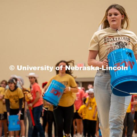 Dance Marathon participants race to place a bucket in a game of tic-tac-toe. HuskerThon Dance Marathon 2024. University of Nebraska–Lincoln students raised $83,702.24 during the annual HuskerThon. Also known as Dance Marathon, the event is part of a nationwide fundraiser supporting Children’s Miracle Network Hospitals. The annual event, which launched in 2006, is the largest student philanthropic event on campus. The mission of the event encourages participants to, “dance for those who can’t.” All funds collected by the Huskers benefit the Children’s Hospital and Medical Center in Omaha. March 2, 2024. Photo by Kirk Rangel.