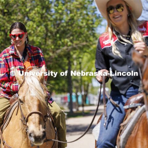 Alyssa Sturtevant rides a horse being led by Rodeo Club member Jadyn Fleischman. The Nebraska Rodeo Team gave Huskers a chance to be up close to their horses and even go for a ride. The team filled the space northwest of the Union to help promote their Nebraska Cornhusker College Rodeo being held Friday and Saturday. April 29, 2024. Photo by Craig Chandler / University Communication and Marketing.