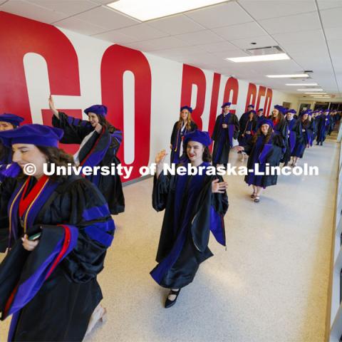 College of Law graduates proceed to court for the commencement ceremony. College of Law commencement in Devaney on the volleyball court. May 3, 2024. Photo by Craig Chandler / University Communication and Marketing.