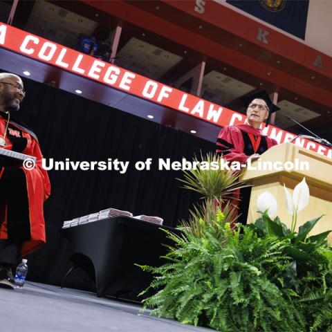 Dean Richard Moberly welcomes the crowd while Chancellor Rodney D. Bennett listens. College of Law commencement in Devaney on the volleyball court. May 3, 2024. Photo by Craig Chandler / University Communication and Marketing.