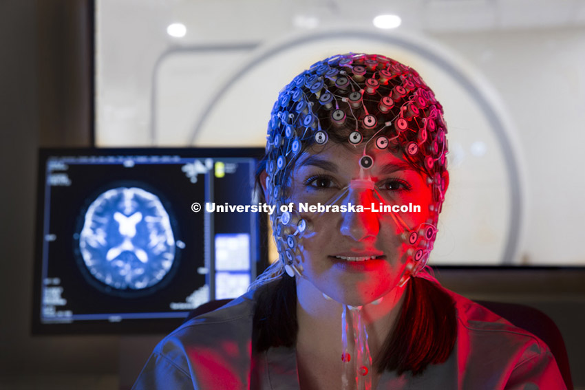 2.  Andrea Meinders, an undergraduate student working in the CB3 lab, demonstrates the MRI compatible High Density EEG Net. Behind her is the new MRI System. CB3 's new MRI in east stadium is up and running. October 29, 2013. Photo by Craig Chandler / University Communications