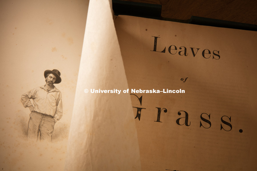 It was discovered that the original 1855 edition of “Leaves of Grass” has variations across copies, due to Walt Whitman’s stop-press revisions, and the fact that it was produced on a hand printing press, which allowed for type to move and fall off. A new grant awarded to the University of Nebraska will allow researchers in the Center for Digital Research in the Humanities (CDRH) to examine about 20 of the original copies to record and research the variations and build an online variorum accessible to scholars and casual readers alike.
Ken Price, Hillegass Professor of English and co-director of the CDRH shows students some of the items in the Whitman Collection of Love Library. Price will oversee the research on the grant. August 23, 2016. Photo by Craig Chandler / University of Nebraska.