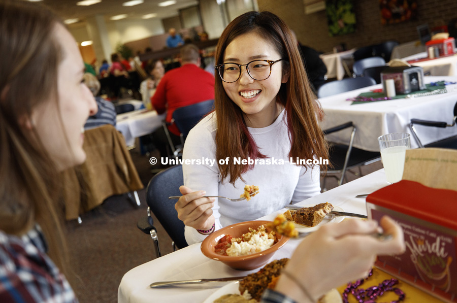 Amy Leiferman, left, and Rong Fan sample lunch Tuesday. The two first-year graduate students in nutrition took a bit of everything and shared to taste it all. It's Fat Tuesday at the East Campus Dining Hall. Chef Ron White, who grew up in uptown New