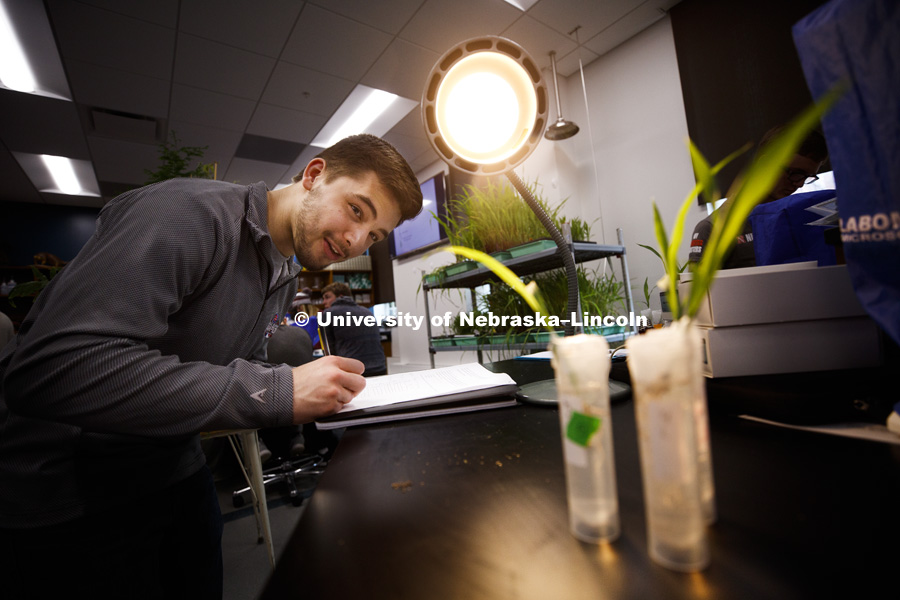 Jonathan Vidlak eyes his plants during a group experiment to measure photosynthesis. Students in LIFE 121L - Fundamentals of Biology 2 Laboratory, taught by Altangerel "Auggie" Tsogtsaikhan, graduate student in biological sciences, in Brace Lab. March 15,