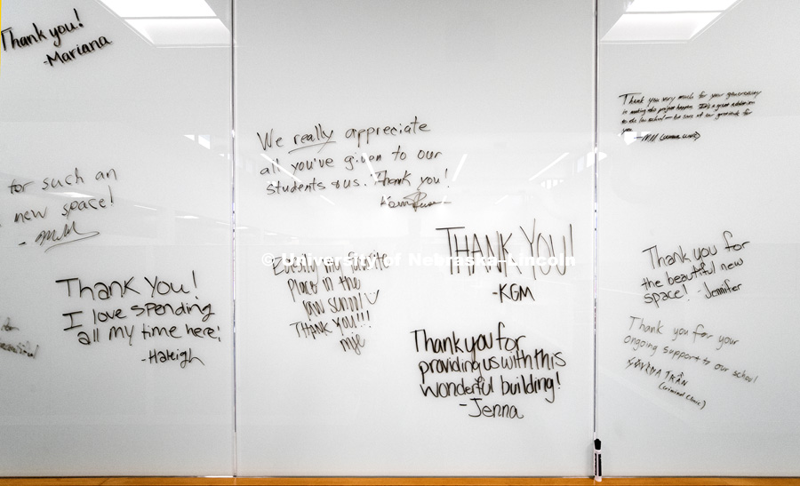 Students write out thank-you's on a glass marker wall to donors attending the open house. Opening of new Marvin and Virginia Schmid Law Clinic and unveiling of former Dean Susan Poser portrait. March 31, 2017. Photo by Craig Chandler / University