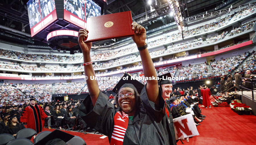 Ashleigh Gildon shows off her architecture diploma to her family and friends in the arena. Students received their undergraduate diplomas Saturday morning in Lincoln's Pinnacle Bank Arena. 2452 degrees were awarded Saturday morning. May 6, 2017. Photo by