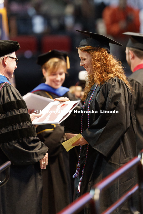 Courtney Everhart accepts her College of Agricultural Sciences and Natural Resources diploma. She was also a ROTC student commissioned in the United States Army during a separate weekend ceremony. Students received their undergraduate diplomas Saturday