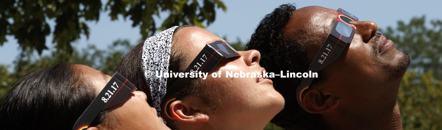 Students modeling the free eclipse glasses being handed out for the August 21, 2017 total eclipse viewable on the Nebraska campus. July 25, 2017. Photo by Craig Chandler / University Communication.