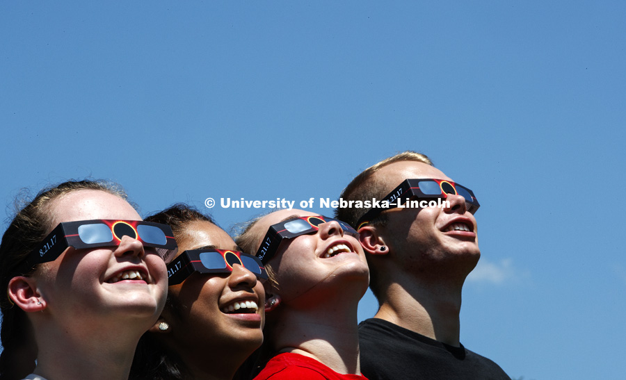 Students modeling the free eclipse glasses being handed out for the August 21, 2017 total eclipse viewable on the Nebraska campus. July 25, 2017. Photo by Craig Chandler / University Communication.