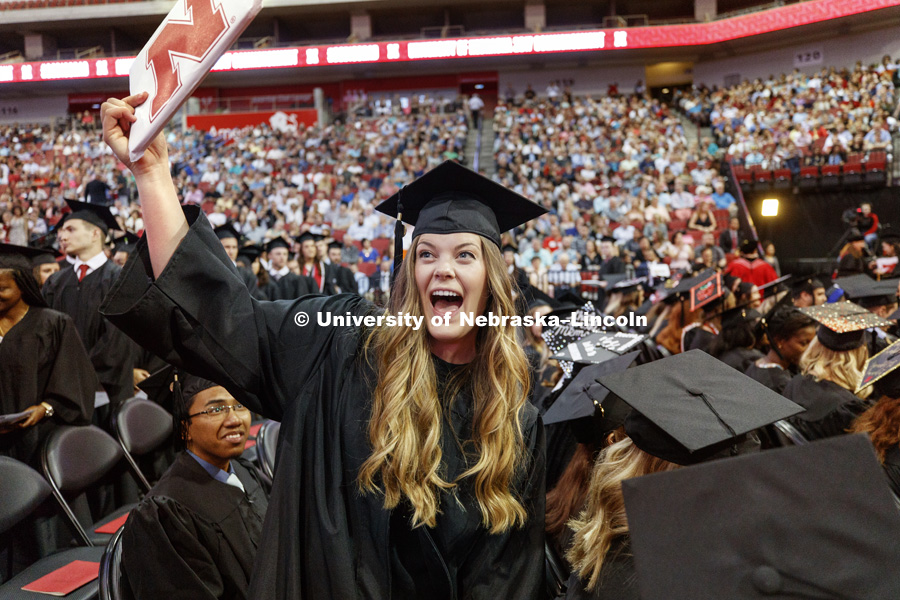 Anne Backman shows off her College of Business diploma to family and friends during August Commencement at Pinnacle Bank Arena. August 12, 2017. Photo by Craig Chandler / University Communication.