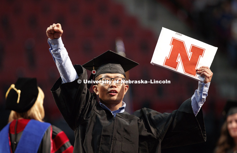 Rucao Wang celebrates his College of Business degree. August Commencement at Pinnacle Bank Arena. August 12, 2017. Photo by Craig Chandler / University Communication.