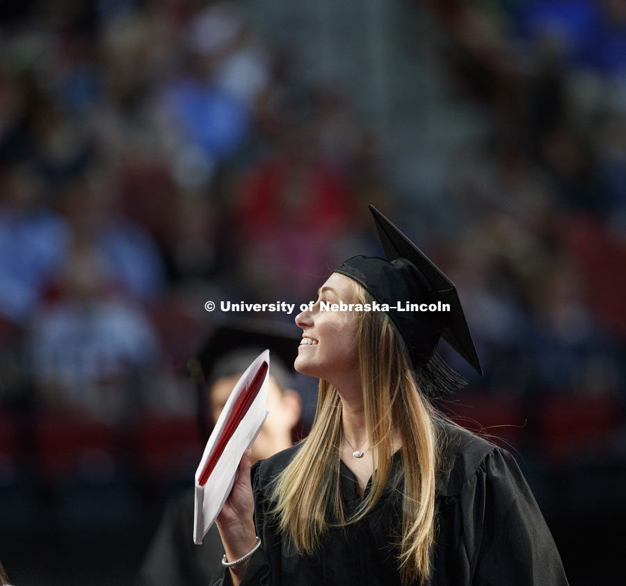 Abigail Akin smiles to the crowd after receiving her diploma. August Commencement at Pinnacle Bank Arena. August 12, 2017. Photo by Craig Chandler / University Communication.