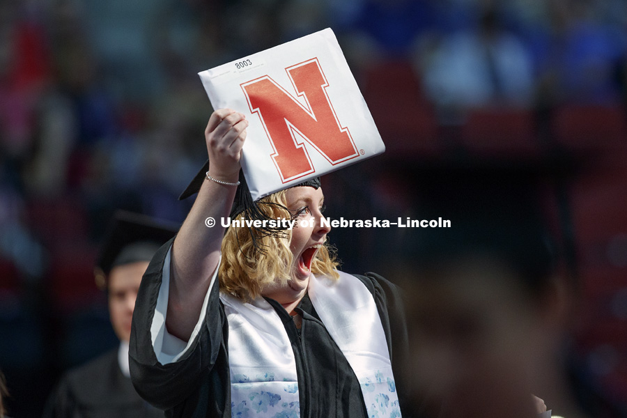 Mikayla Cruickshank holds up her college of Journalism and Mass Communication diploma to acknowledge her family and friends. August Commencement at Pinnacle Bank Arena. August 12, 2017. Photo by Craig Chandler / University Communication.