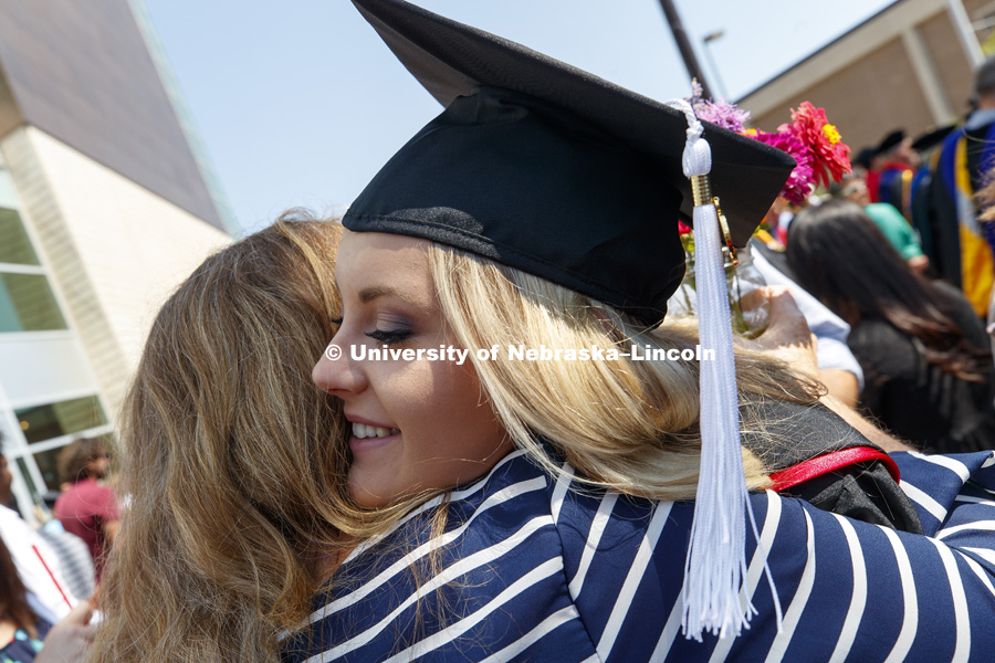 Taylor Kuhlman receives a hug outside Pinnacle Bank Arena following August Commencement. August 12, 2017. Photo by Craig Chandler / University Communication.
