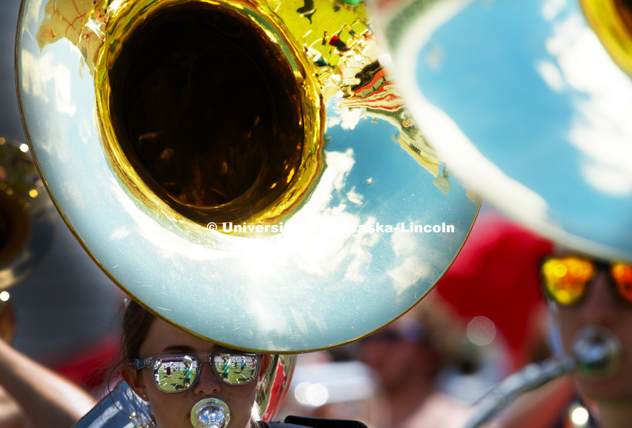Band members are reflected in mirrored sunglasses as Kelsey Reeves plays her sousaphone during Cornhusker Marching Band practice in Memorial Stadium. August 16, 2017. Photo by Craig Chandler / University Communication.