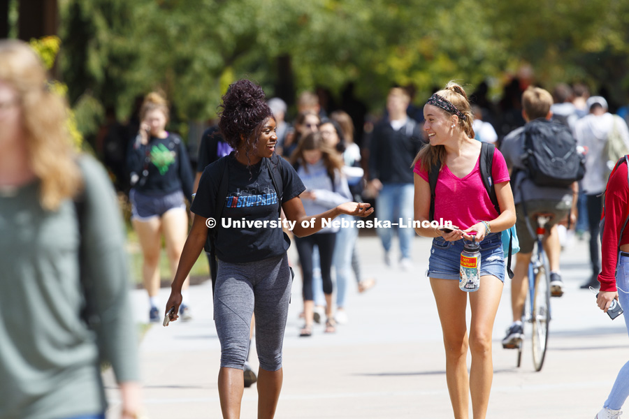 Khadiya Mengelkamp, freshman from Lincoln, and Clare Caraghar, freshman from Colorado, talk while walking on their way back from class. September 5, 2017. Photo by Craig Chandler / University Communication.