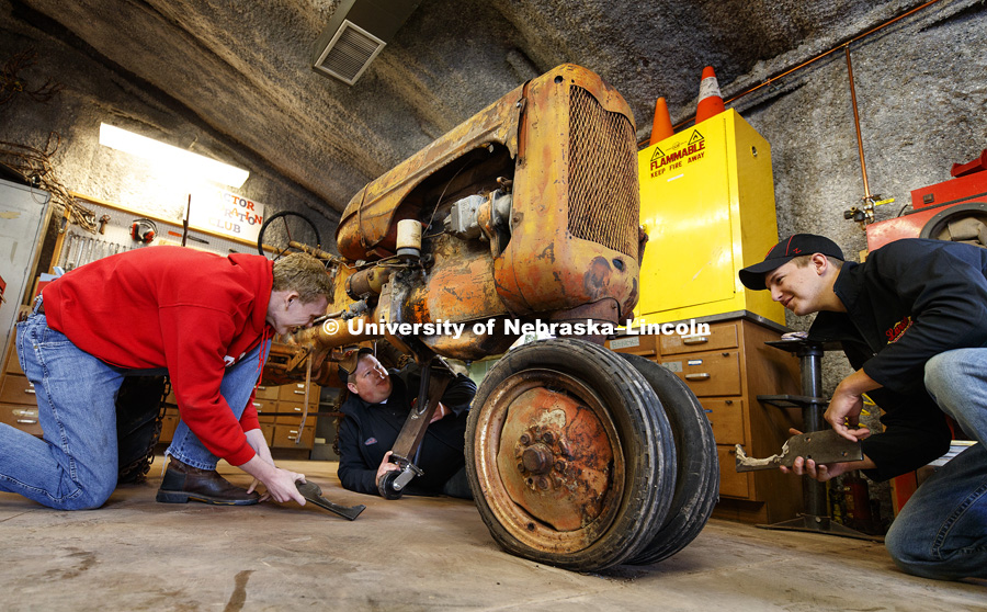 Tractor restoration club members Kiel Kruse, Joshua Bauer and Jaythan Scheideler work with support pieces that will be attached to the old tractor so it can be moved around for preservation. Members of the club will preserve a tractor that belonged to the