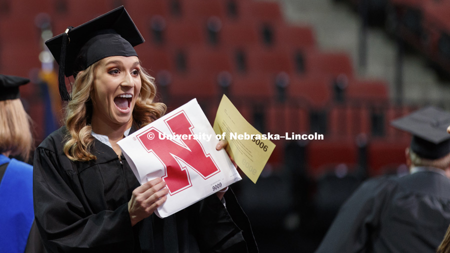Tayler Bauer shows off her CEHS diploma. Undergraduate Commencement at Pinnacle Bank Arena. December 16, 2017. Photo by Craig Chandler / University Communication.