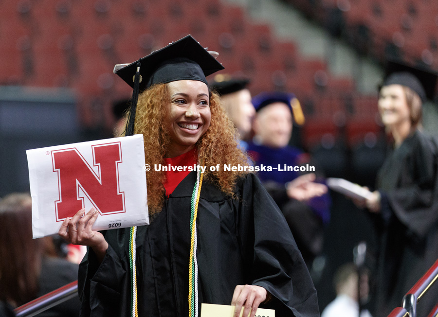 Wylicia Dorsey shows off her CEHS diploma to family and friends. Undergraduate Commencement at Pinnacle Bank Arena. December 16, 2017. Photo by Craig Chandler / University Communication.