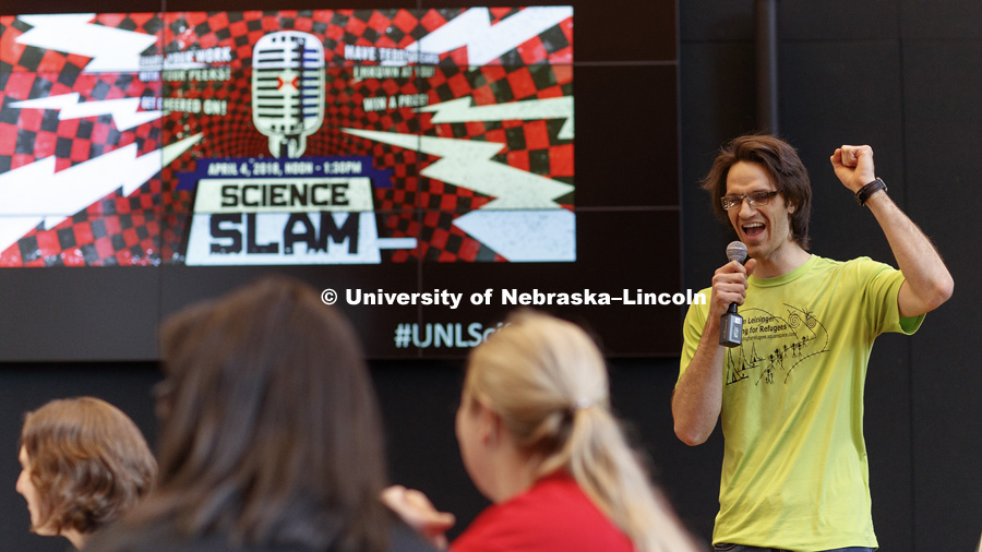 Karl Ahrendsen, graduate student in physics, gives his slam speech. Science Slam is a campus-wide contest where graduate and undergraduate researchers from ALL SCIENTIFIC DISCIPLINES are challenged to communicate their work in short, dynamic, and engaging