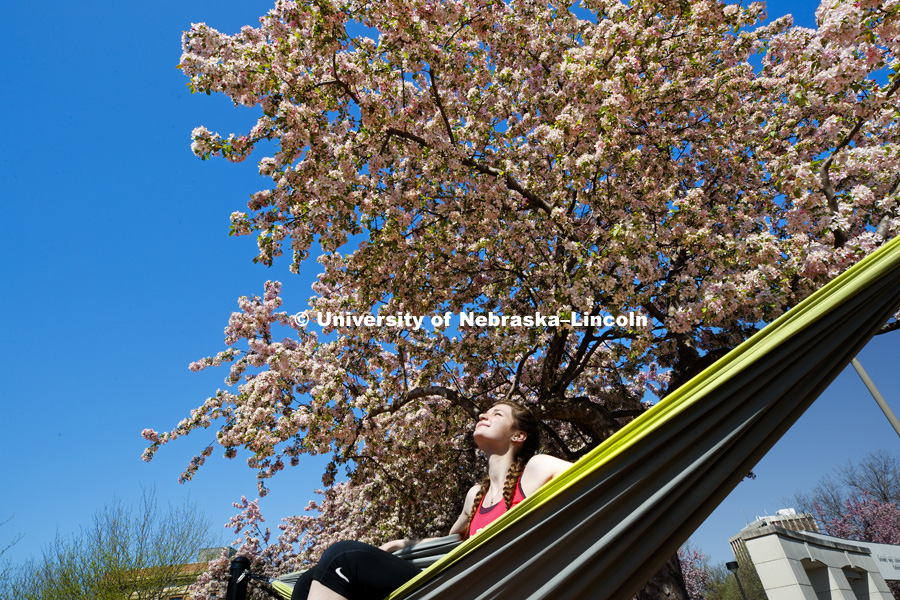 Kelsey Ewert of Ogallala, NE, enjoys the sun and being finished with her junior year of finals as she sits in the hammock outside the Nebraska Union. May 4, 2018. Photo by Craig Chandler / University Communication.