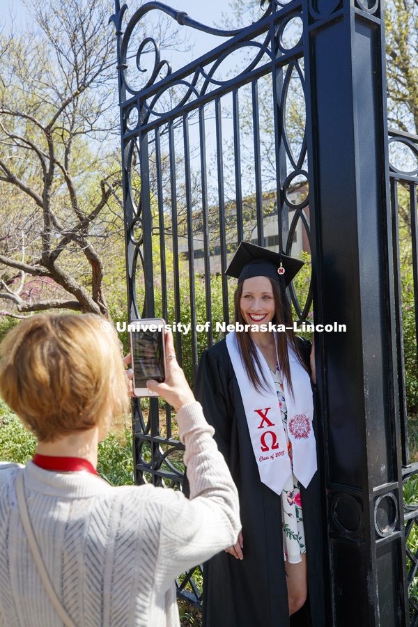 Katlyn LaCroix of South Elgin, IL, poses for a photo for her mom, Debra, outside of Love Library Friday morning.  Katlyn graduates Saturday with an undergraduate degree in actuary science.May 4, 2018. Photo by Craig Chandler / University Communication