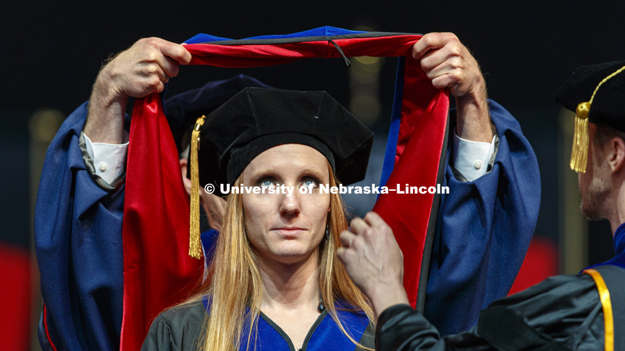 Katherine Schumacher watches as her doctoral hood is lowered over her head. Graduate Commencement at Pinnacle Bank Arena. May 4, 2018. Photo by Craig Chandler / University Communication.