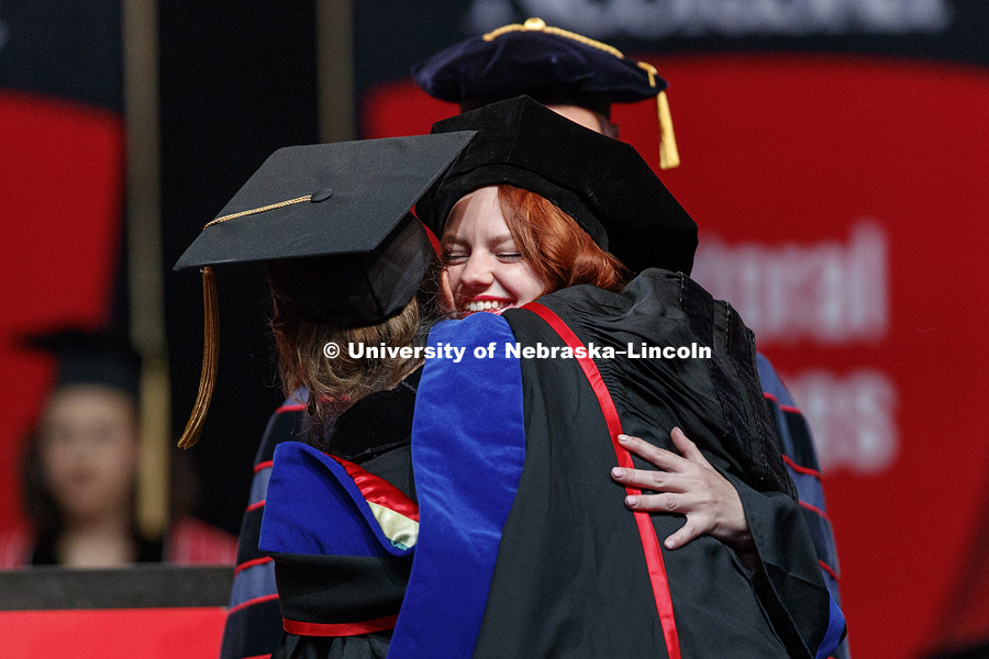Laura White receives a hug from Petronela Radu after White received her doctorate in mathematics. Graduate Commencement at Pinnacle Bank Arena. May 4, 2018. Photo by Craig Chandler / University Communication.