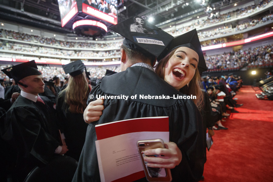 Annie Albin hugs Dakota Anderson after Regent Tim Clare suggested graduates hug, shake hands or fist bump the person next to you. Undergraduate Commencement at Pinnacle Bank Arena. May 5, 2018. Photo by Craig Chandler / University Communication.