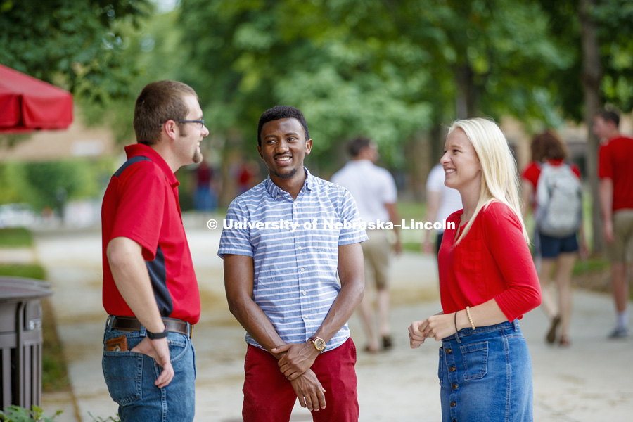 Students laughing and talking together as they cross East Campus. CASNR photo shoot on East Campus. May 29, 2018. Photo by Craig Chandler / University Communication.