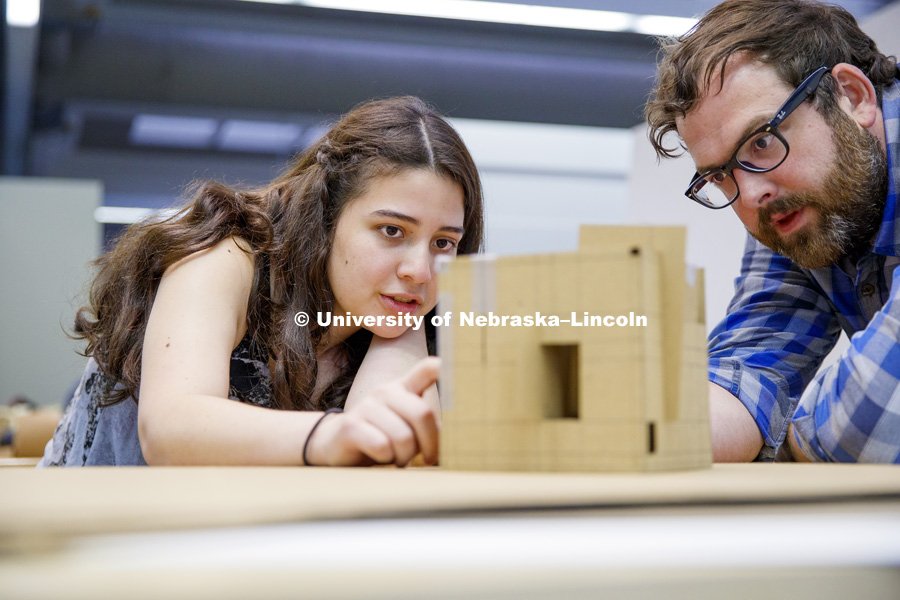 Karolayn Chavez Loor discusses the structural openings and angles on Loor's model with instructor Nate Bicak. Students work on concept models in DSGN 111 - Design Making. June 4, 2018. Photo by Craig Chandler / University Communication.