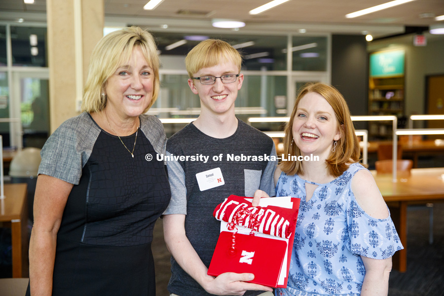 Sam Harvey, center, is surrounded by Executive Vice Chancellor Donde Plowman, left, and his mom, Elisia Flaherty. Sam is a high school junior from Grand Island and scored a perfect ACT score. June 19, 2018. Photo by Craig Chandler / University
